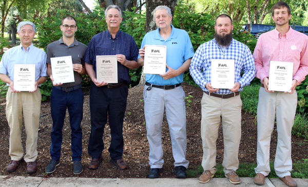AFL employees are recognized for their patents, a symbol of the company's innovation and intellectual property.